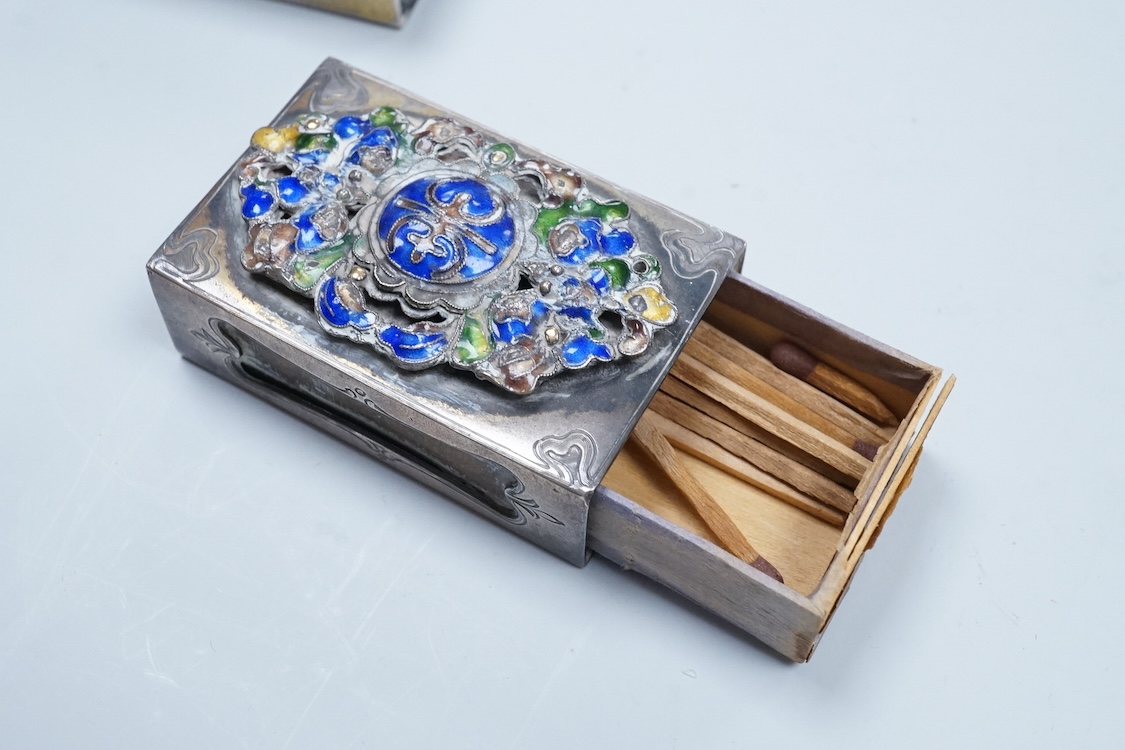 Two North American Edward I. Farmer of New York engraved sterling matchbox slides, one mounted with a jadeite carving, the other with polychrome enamelled surmount, both approximately 60mm.